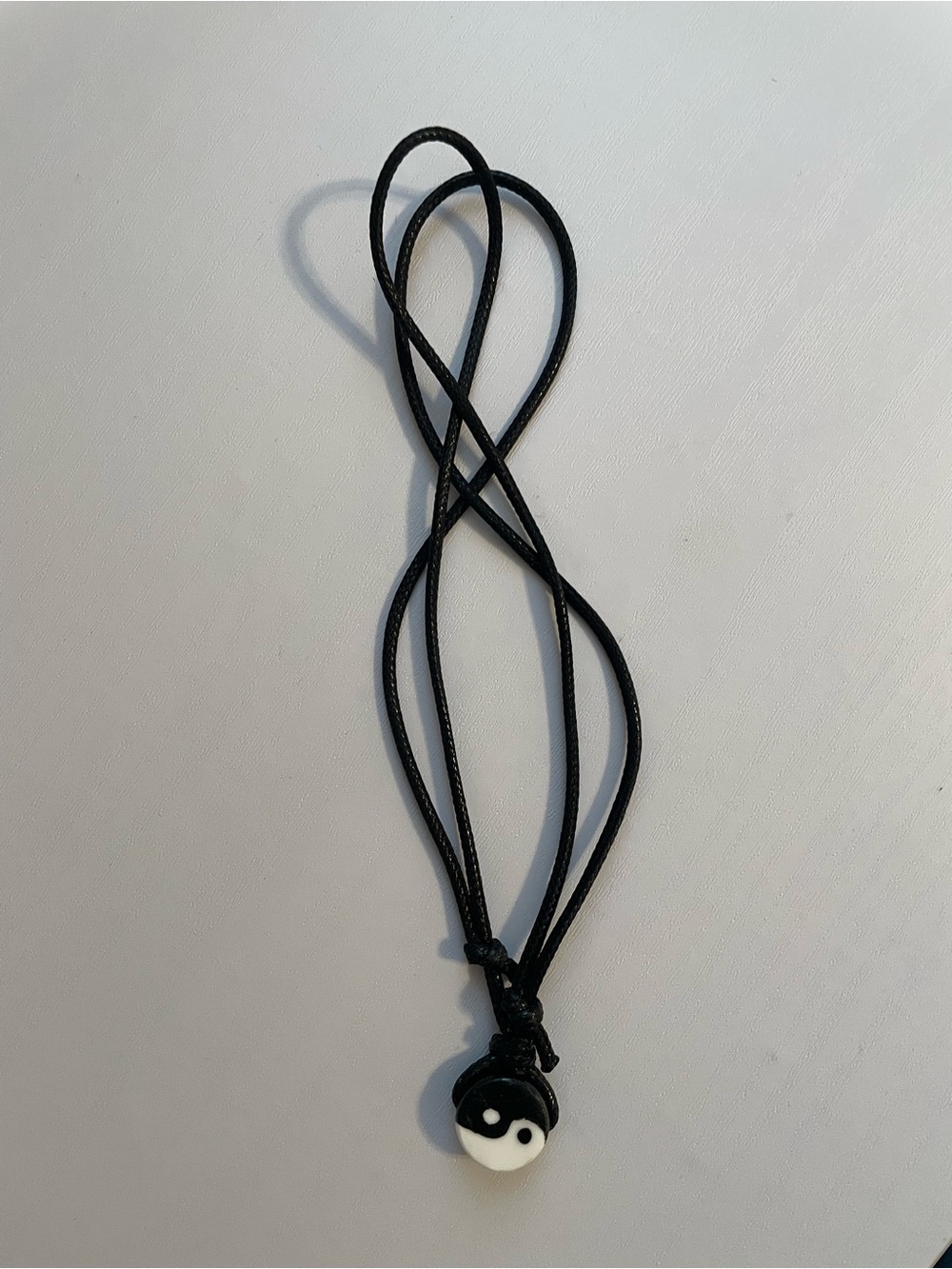 Cord necklace adjustable with yin and yang pendant